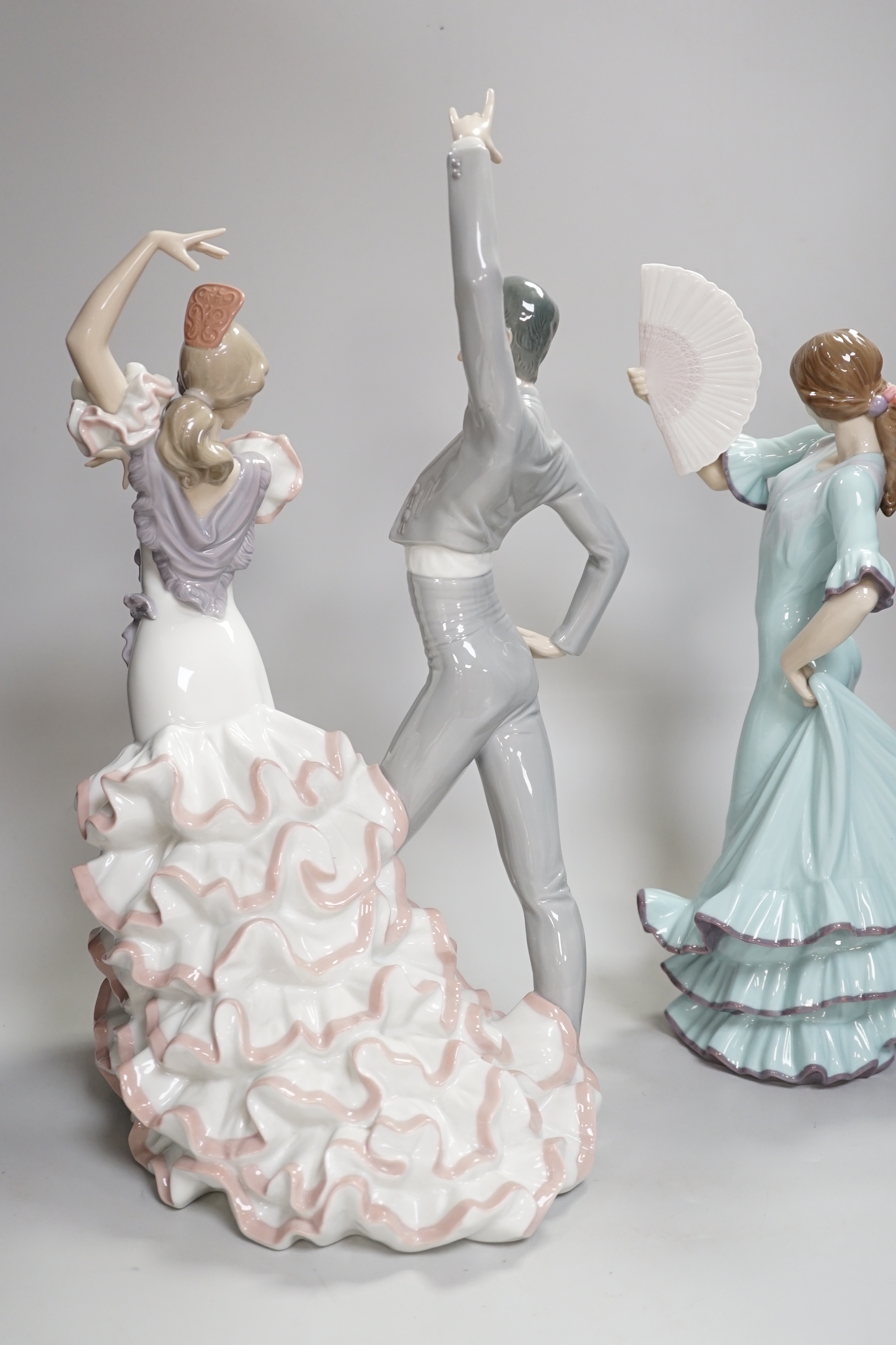 A Lladro centrepiece of two Spanish dancers, ‘A Passionate Dance’, boxed, together with another Lladro dancing figure with a fan, highest 43.5cm